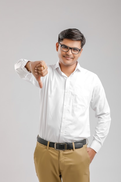 Young indian man showing thumb down