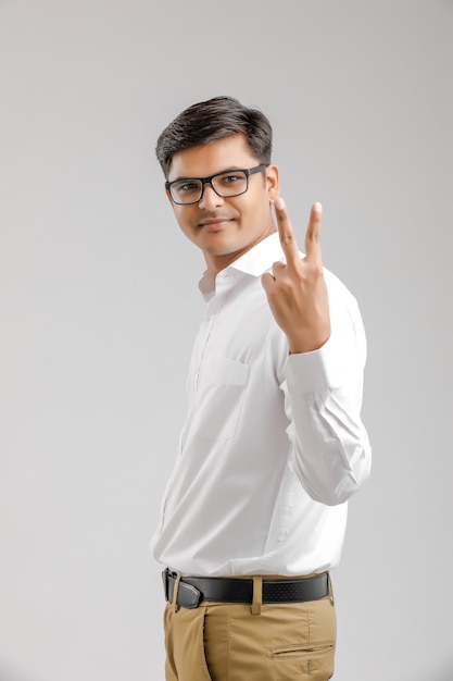 Young Indian man showing victory sign 