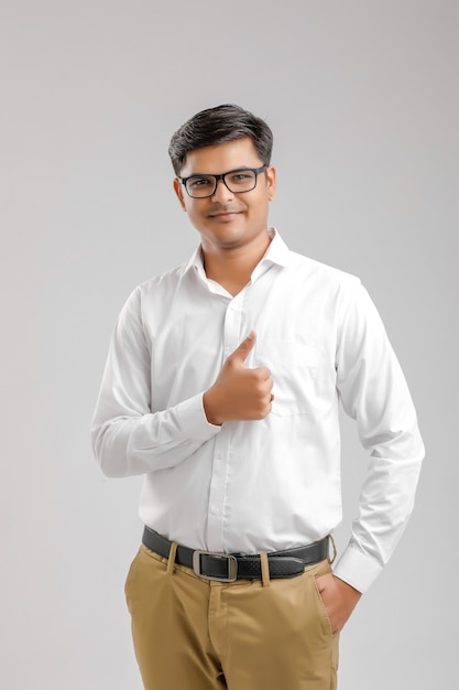 Young Indian man standing and doing thumb up