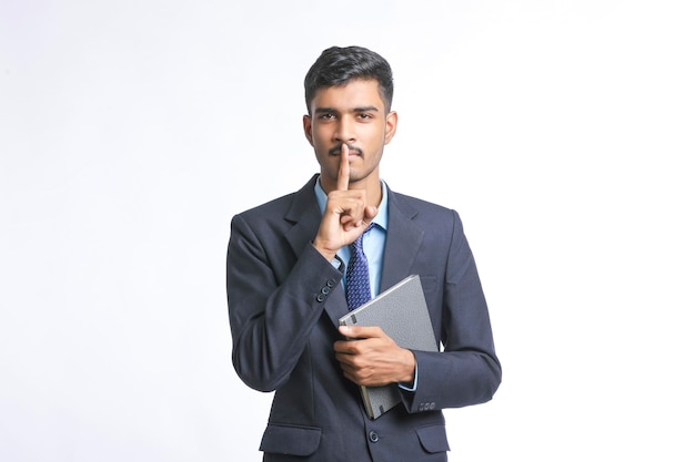 Young indian man in suit and giving expression on white background