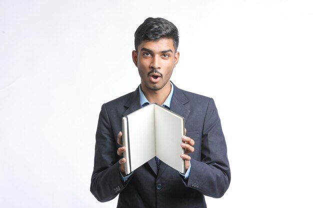 Young indian man in suit and giving expression on white background