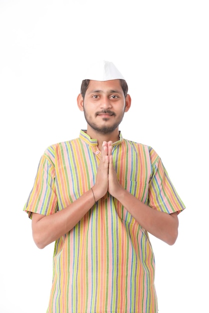 Young indian man in traditional wear and giving namaste or welcome gesture