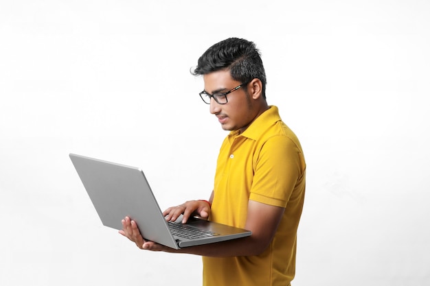 Young indian man using laptop.