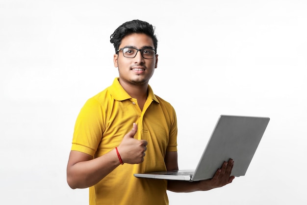 Young indian man using laptop.