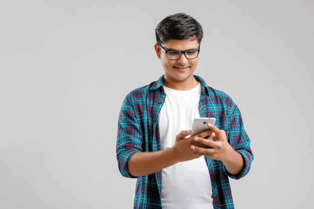 Young indian man using smartphone