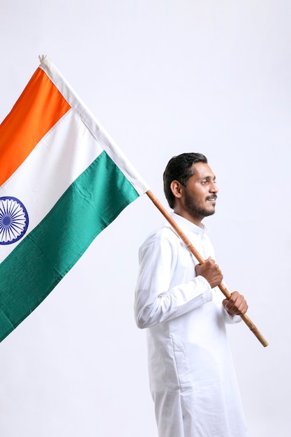 Young indian man waving indian national flag. celebrating independence day