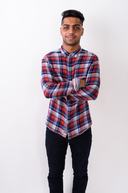 Young Indian man wearing checkered shirt on white