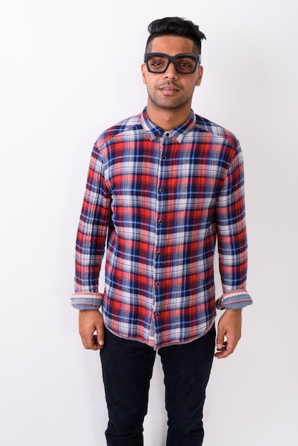 Young Indian man wearing checkered shirt on white