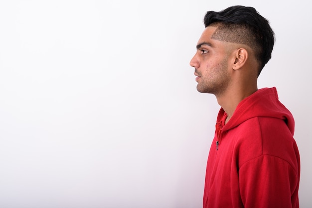 Young Indian man wearing hoodie on white