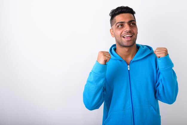 Young Indian man wearing hoodie on white