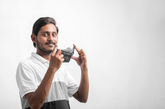 Young indian man wearing mask for protection against virus.