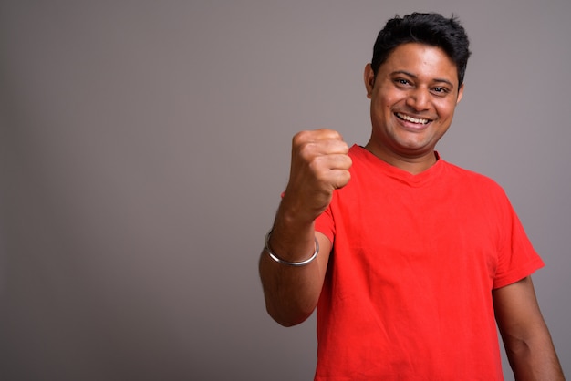 young Indian man wearing red shirt 