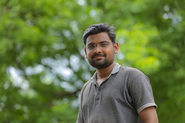 Young indian man with eyeglasses in nature