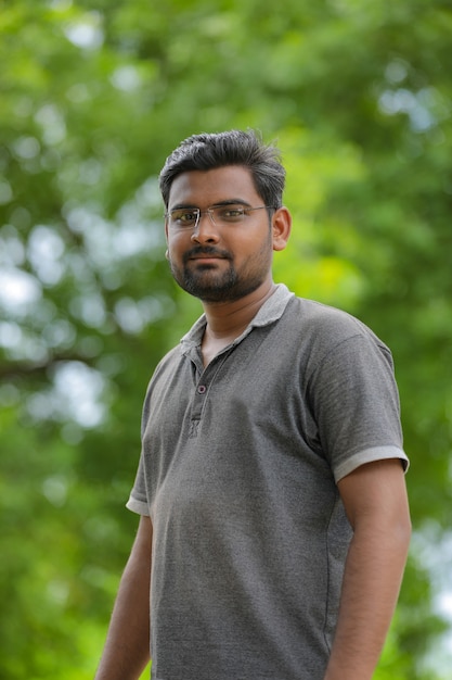 Young indian man with eyeglasses in nature