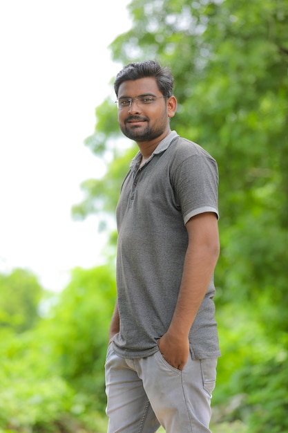 Young indian man with eyeglasses in nature