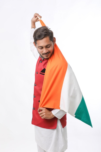 Young indian man with indian flag on white background.