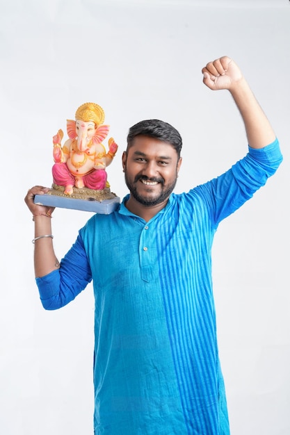 Young Indian man with Lord Ganesha Celebrating Ganesha festival