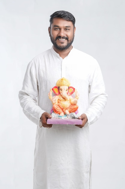 Young Indian man with Lord Ganesha Celebrating Ganesha festival