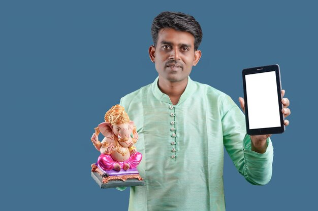 Young Indian man with Lord Ganesha Celebrating Ganesha festival