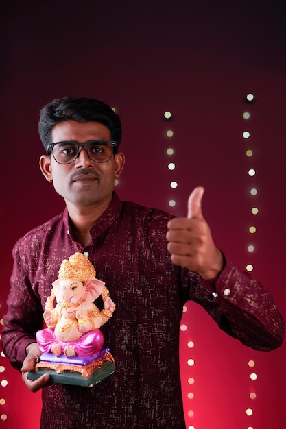 Young Indian man with Lord Ganesha Celebrating Ganesha festival