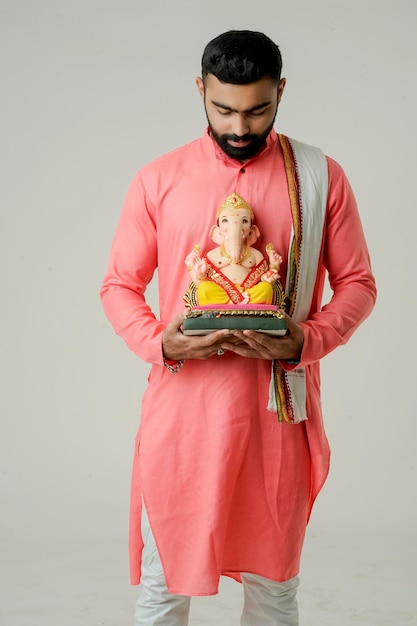 Young indian man with lord ganesha celebrating ganesha festival