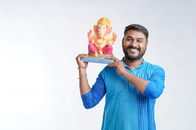 Young Indian man with Lord Ganesha Celebrating Ganesha festival