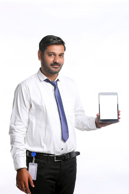 Young indian officer showing tablet screen on white background.