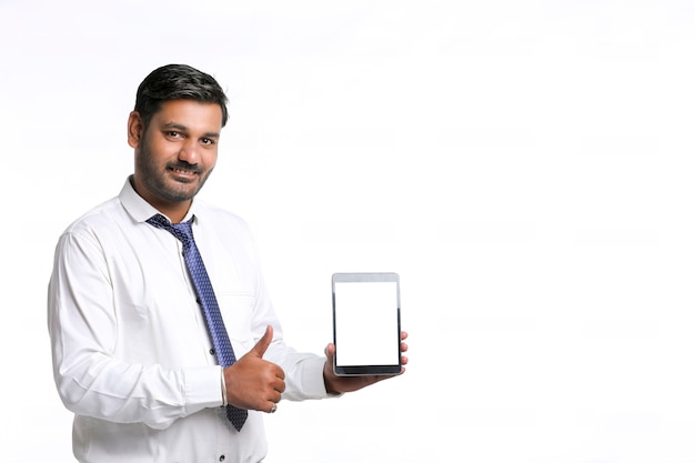 Young indian officer showing tablet screen on white background.