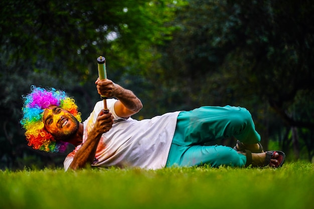 Young Indian playing Holi in park Images