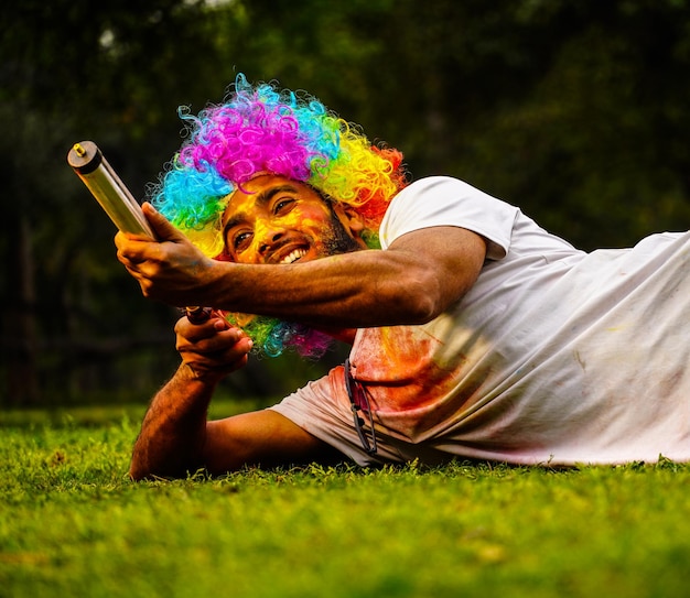 Young Indian playing Holi in park Images