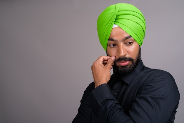 Young Indian Sikh businessman wearing green turban