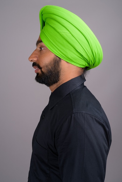 Young Indian Sikh businessman wearing green turban