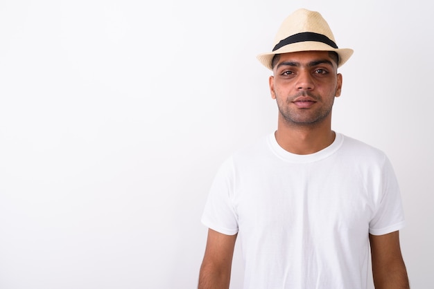 Young Indian tourist man wearing hat on white