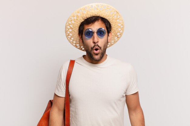 Young indian traveler man scared expression