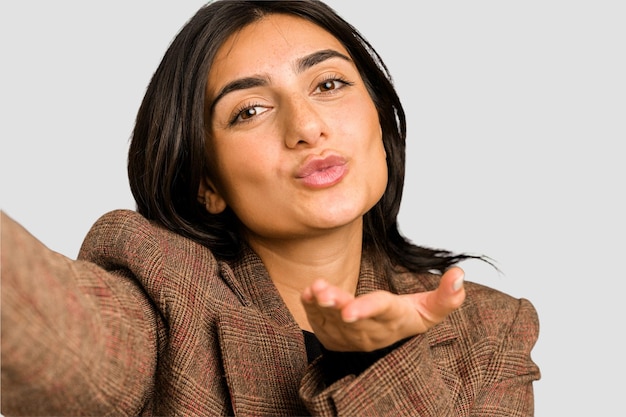 Young indian woman doing a selfie with mobile isolated