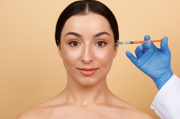 Young Indian Woman Getting Botox Injection To Reduce Eye Wrinkles