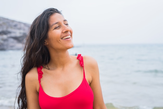 Young indian woman happy on the beach