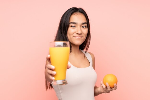 Young Indian woman holding an orange