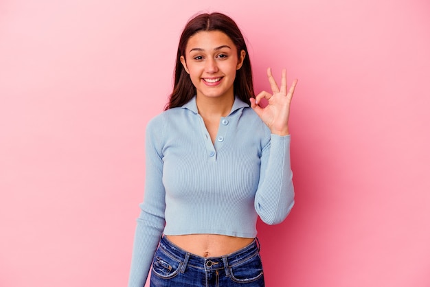 Photo young indian woman isolated on pink cheerful and confident showing ok gesture.