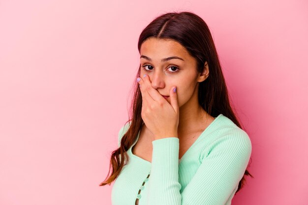 Young Indian woman isolated on pink scared and afraid.