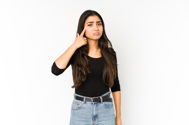 Young indian woman isolated on purple background crying, unhappy with something, agony and confusion concept.