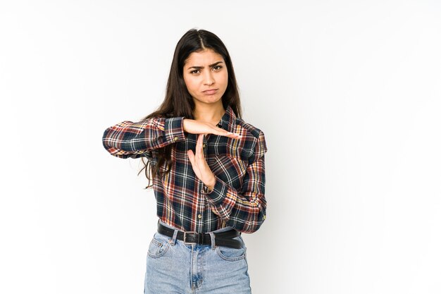 Young indian woman isolated on purple background showing a timeout gesture.