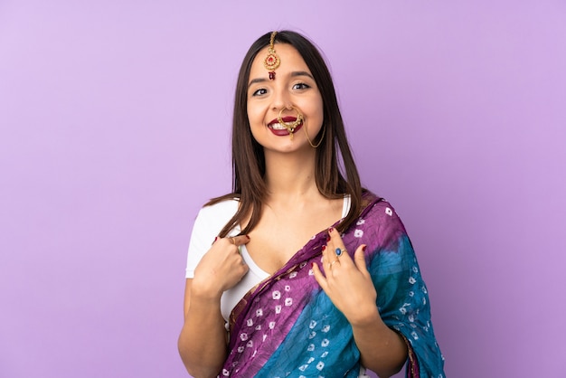 Young Indian woman isolated on purple background with surprise facial expression