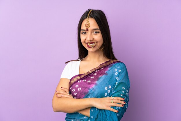 Young indian woman isolated on purple