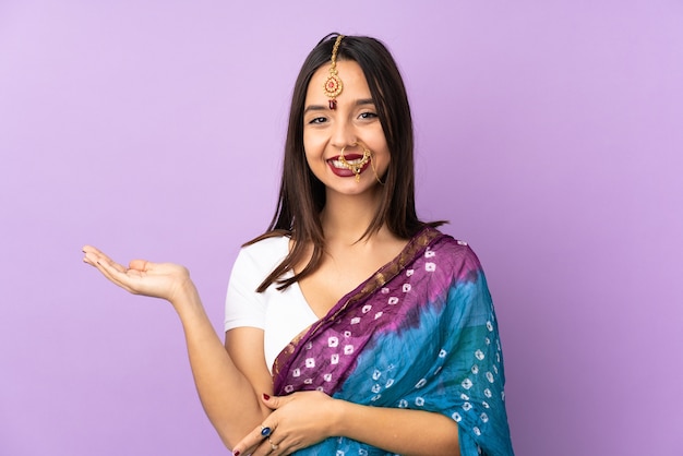 Young indian woman isolated on purple