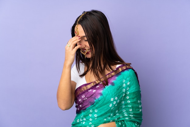 Young Indian woman over isolated wall