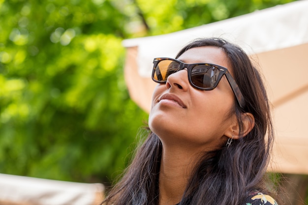 Young indian woman looking up