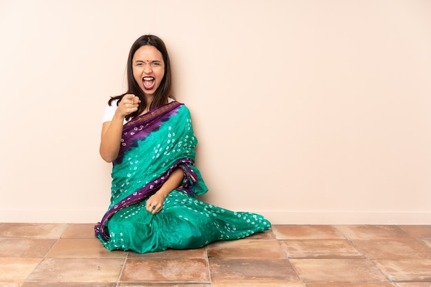 Young Indian woman sitting on the floor