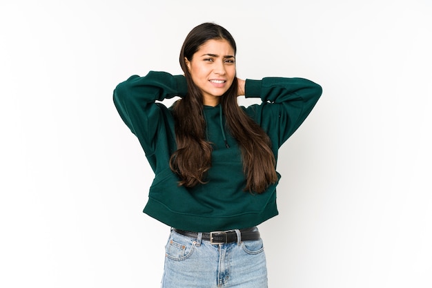 Young indian woman touching back of head, thinking and making a choice.