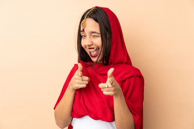 Young indian woman over wall